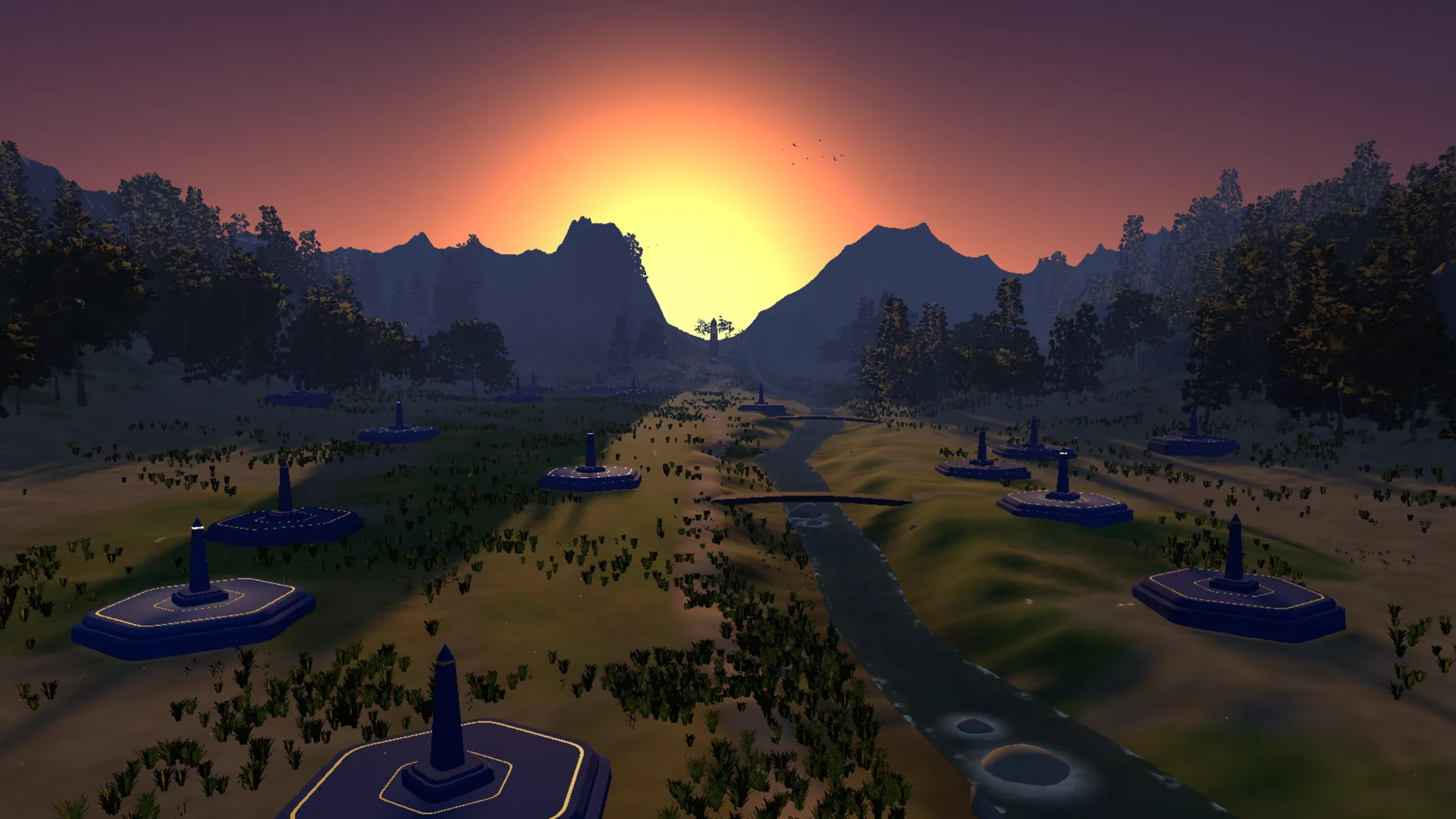 The Vale at sunset: plots along a stream running toward the mountains, the sun low between the peaks.