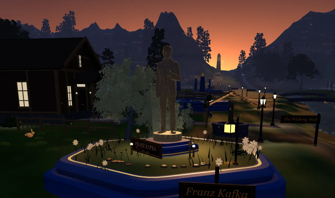 Kafka's tribute plot in the Vale at golden hour: the statue over its garden, the lamps just lit